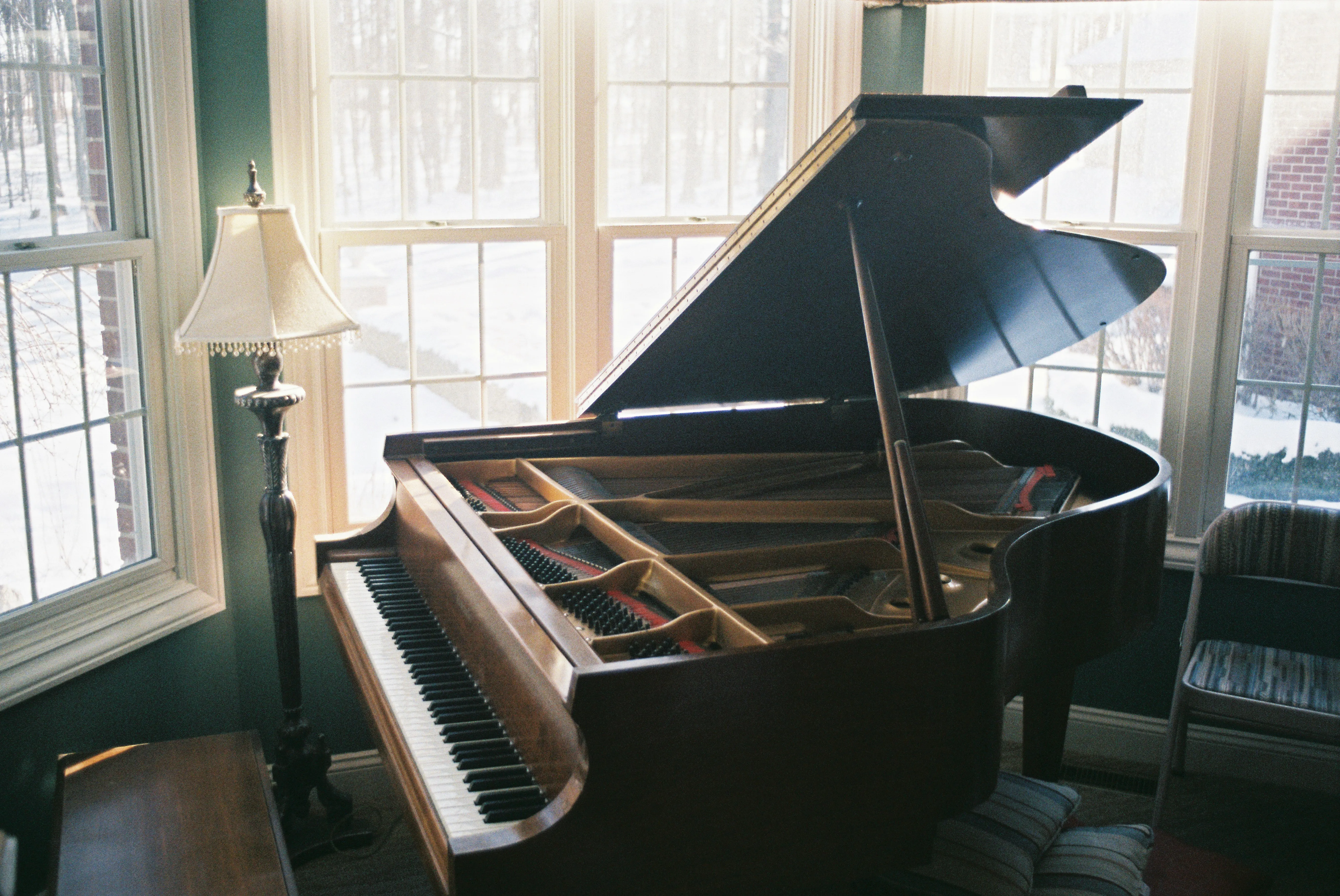 A black grandpiano in a well-lit room