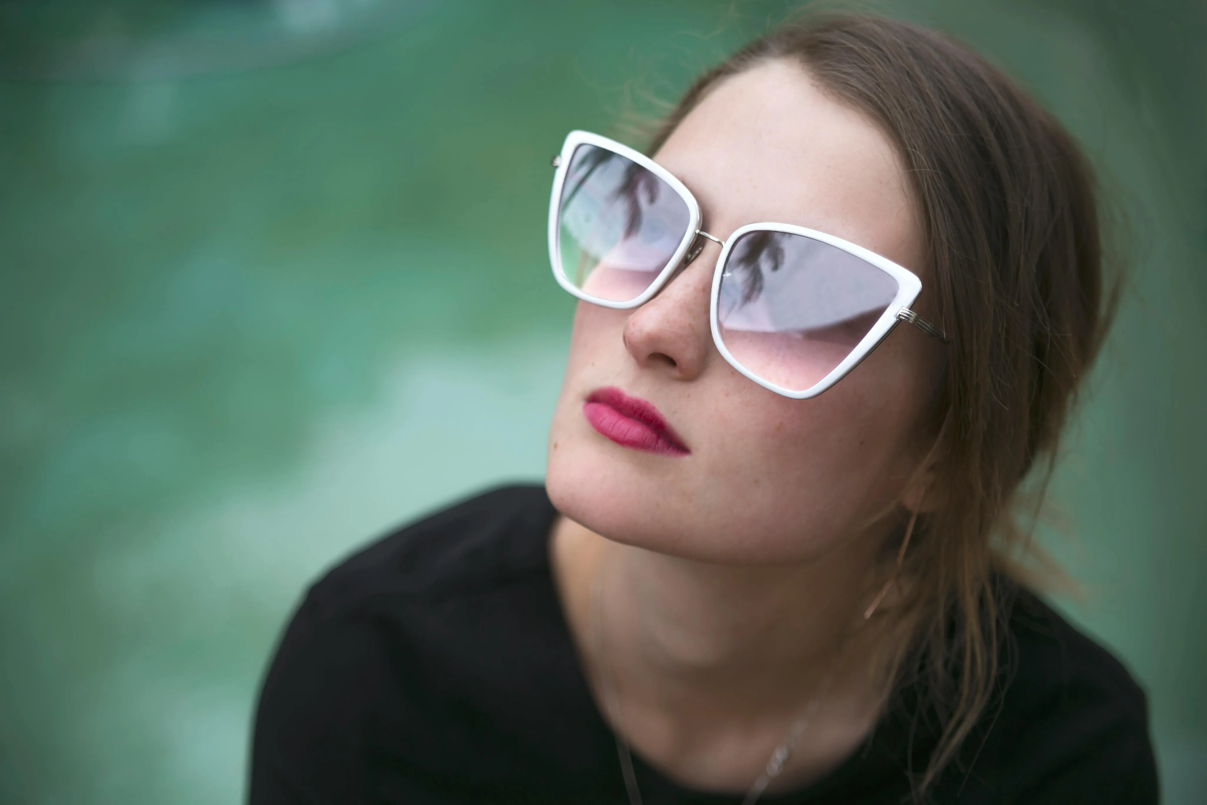 A person wearing a pair of white butteryfly sunglass.