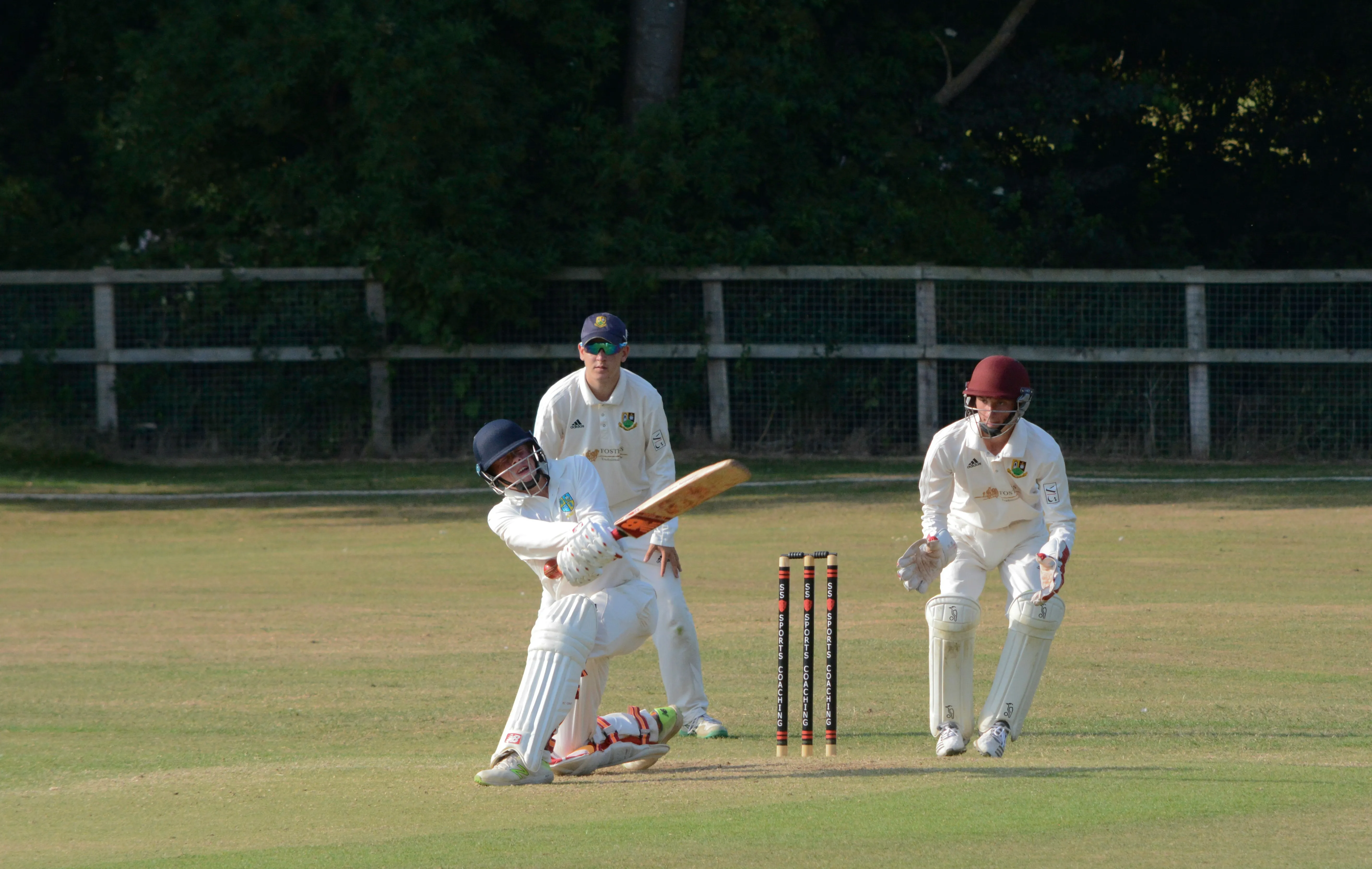 Men driving the ball while playing.webp