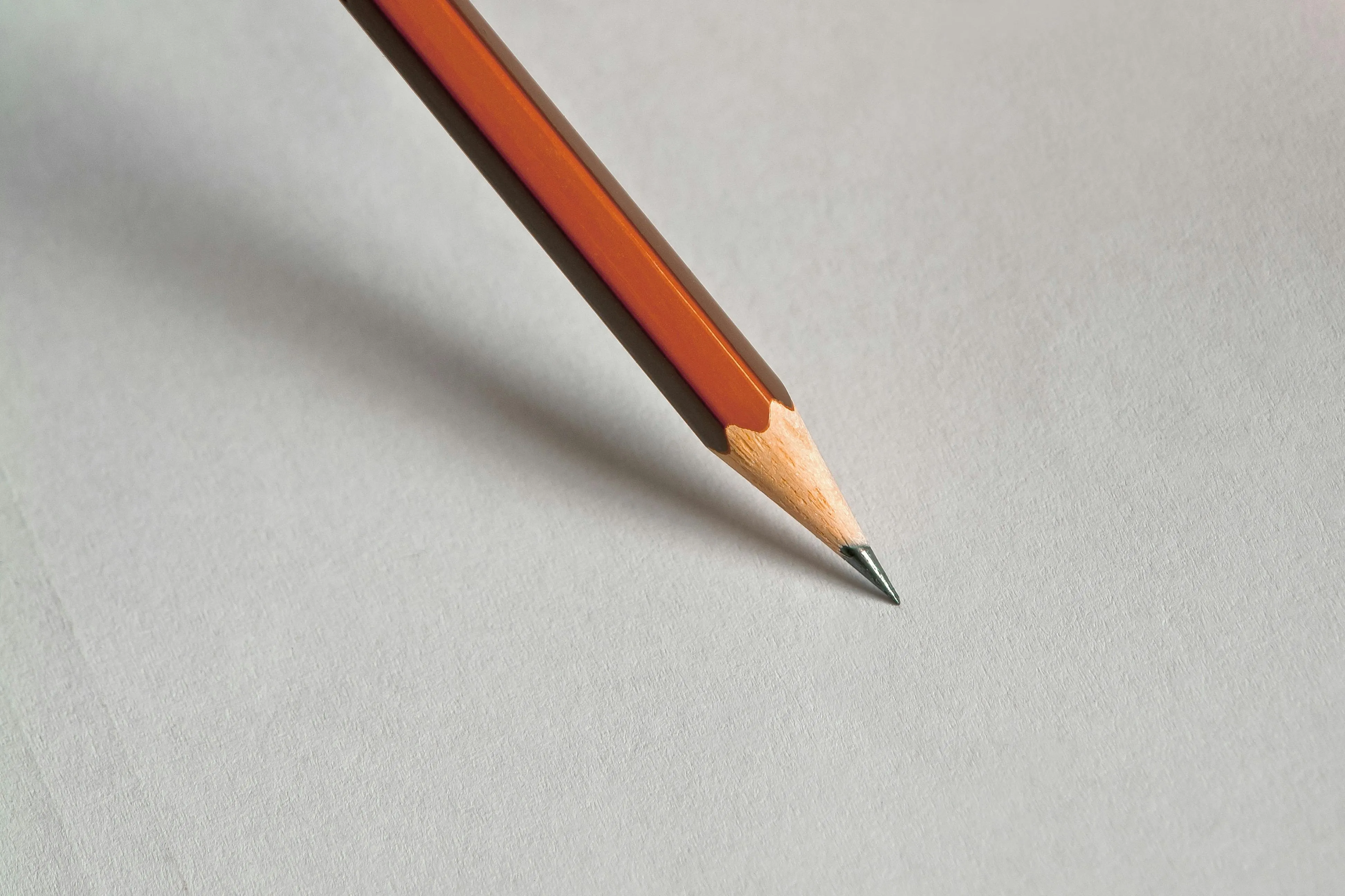 A shaved pencil on a gray background