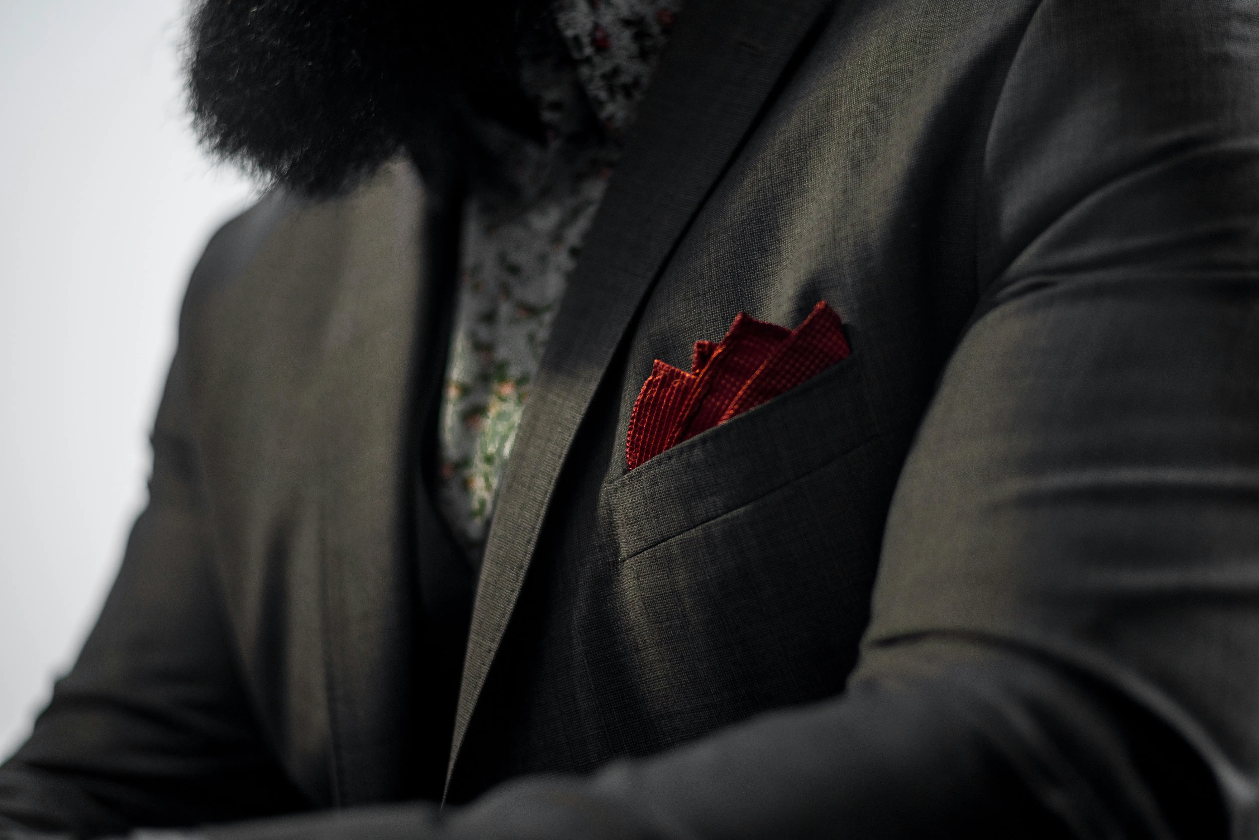 A person using a red handkerchief as pocket square.